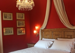 Canopy bed and red walls for the master bedroom