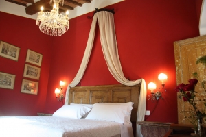 Canopy bed and red walls for the master bedroom